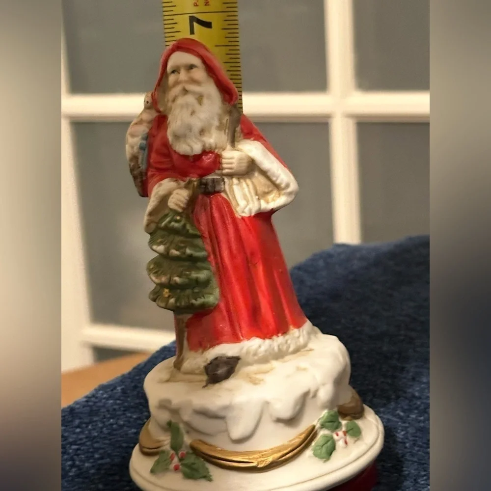 Revolving porcelain Santa musical figure plays Santa Claus is Coming to Town.